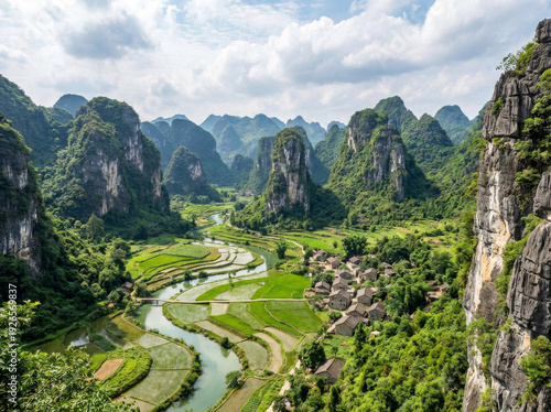 Scenic view of a winding river flowing through lush green rice terraces and karst mountains under a cloudy sky.