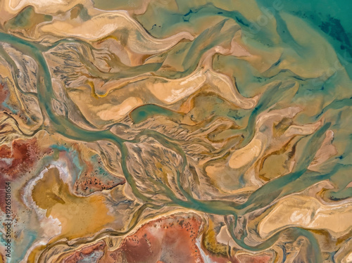 Aerial view of a winding river delta with intricate patterns of water and land formations.
