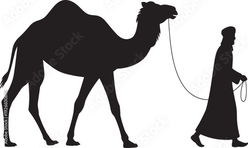 Silhouette of a man in traditional clothing leading a camel by a rope desert
