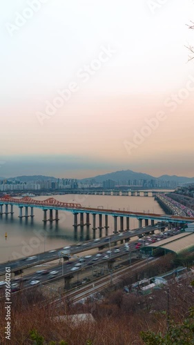 Wallpaper Mural Busy traffic on Gangbyeonbuk-ro expressway and Dongho Bridge at winter sunset with golden hour light in Seoul South Korea - vertical panning aerial hyperlapse Torontodigital.ca