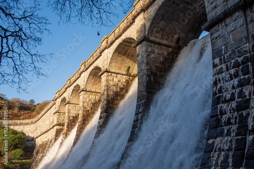 Water cascading over dam at Burrator Reservoir in Dartmoor National Park, Devon, UK