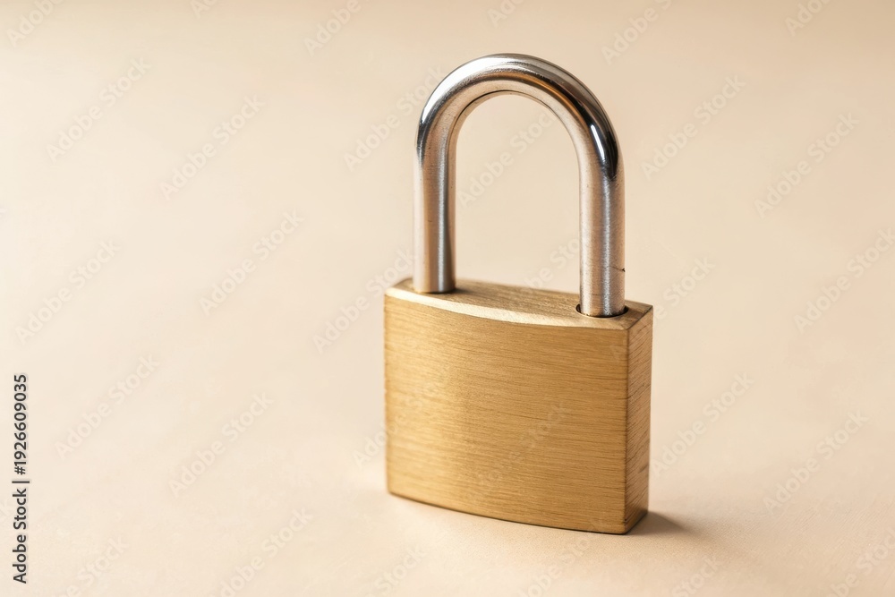 Fototapeta premium Golden Padlock on Neutral Background with Inspirational Lighting and Textured Surface for Security and Safety Theme