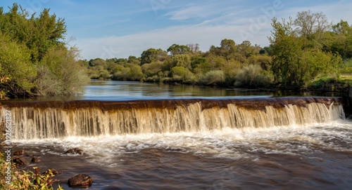 Smooth brown river spilling...