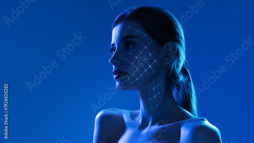 Foto High tech poster side portrait woman with illuminated facial grid in blue light