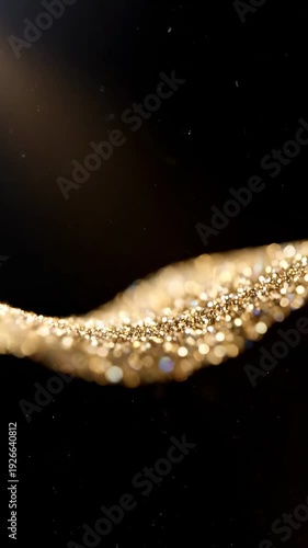 Wallpaper Mural Golden shimmering particles flow gracefully across a dark background, creating a mesmerizing visual effect that captures the essence of light and texture in motion Torontodigital.ca