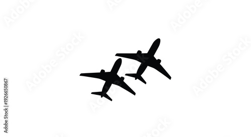 Two commercial airplanes flying in formation a striking silhouette