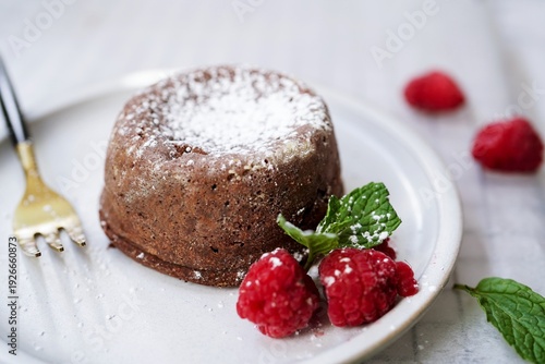 Homemade Chocolate molten lava cake served with raspberries and powdered sugar