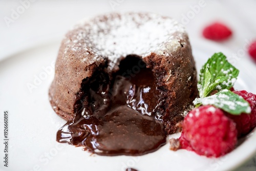 Homemade Chocolate molten lava cake served with raspberries and powdered sugar