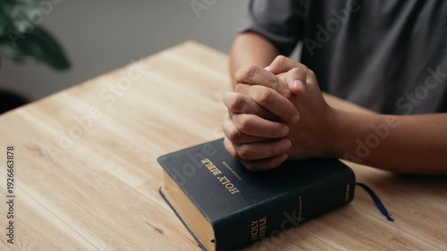 Wallpaper Mural Hands clasped prayer with Holy Bible for Christian faith, spirituality, worship, devotion, hope, and religious belief, prayer time in church, trust in God, and spiritual guidance. Torontodigital.ca