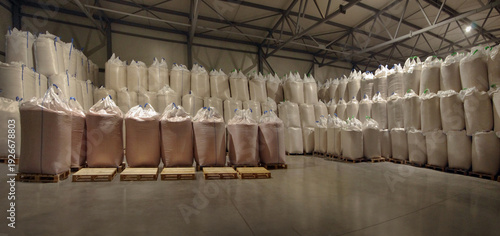 big-bags with grain or fertilizers on wooden pallets in a agriculture warehouse
