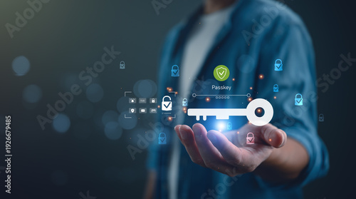 Close up of hand holding virtual passkey icon with shield for secure login. Concept of passwordless authentication, cyber security, digital identity protection, and future technology.