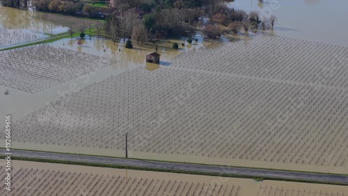 Wallpaper Mural Aerial view of floodwaters submerge a landscape of vineyards and a lone building, creating a scene of devastation, Flooded field, Gironde, France. Torontodigital.ca
