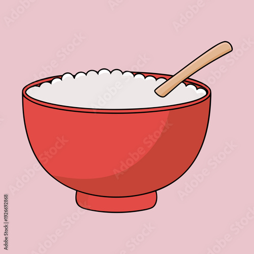 A red bowl filled with white rice and a wooden spoon