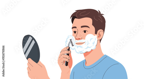 A young man with brown hair in a blue shirt shaves his face with a razor and foam on a plain white background.