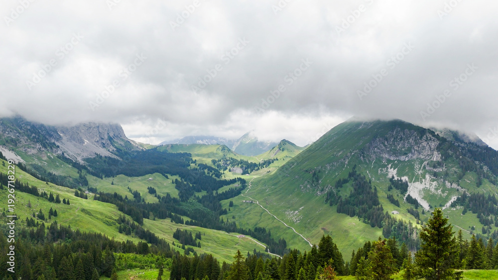 Obraz premium Hiking trail round the Gastlosen mountain in the Swiss Alps. outdoor adventure, hiking destination in in Switzerland, alpine trees and mountains in background. Outdoor travel destination. Beautiful na
