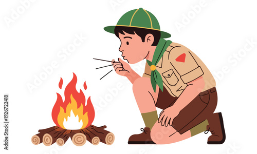 Boy Scout Kneeling and Blowing Air to Ignite Campfire