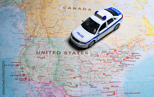 Police car model on map of USA.