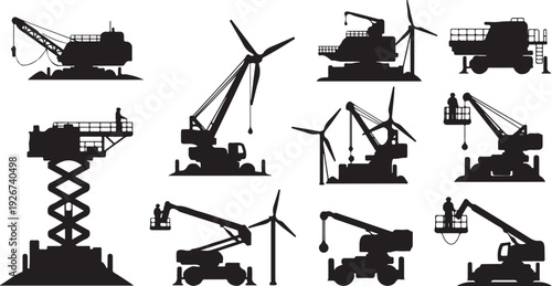 Silhouettes of construction equipment and wind turbines at work