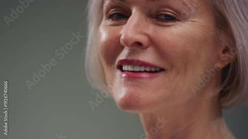 Elderly woman neck and good teeth smile. Old female tightens and stretches chin perfect skin. Care for senior persons medicine and treatment. Cosmetology or dermatology for wrinkles. Close up macro