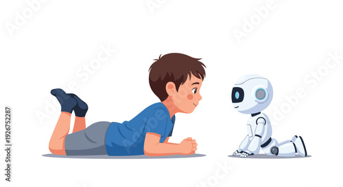 A young boy lies on the floor while looking directly at a small white humanoid robot with a blue digital face.