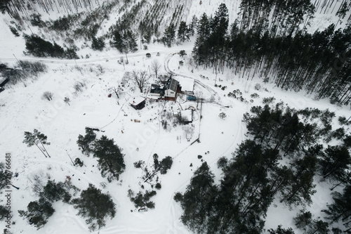A view of a snow-covered house, seen from a drone