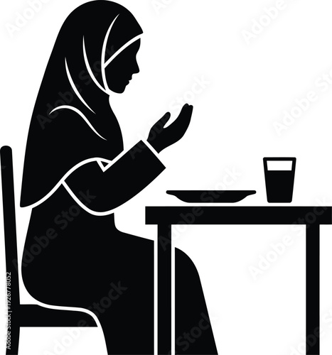 Contemplation and Sustenance: A silhouette captures a moment of quiet reflection as a woman prepares for her meal. Her serene pose is a testament to the introspective spirit.