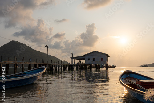 Fotografie Tropical Beach Sunrise with Golden Hour Light and Calm Water at Saracen Bay