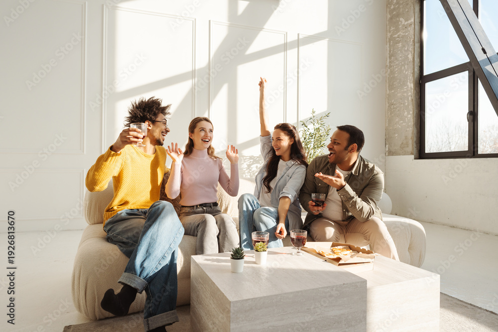 Fototapeta premium Group of happy positive diverse multinational friends drinking red wine, eating tasty pizza hands up