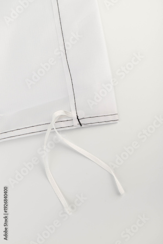 Seams on nylon fabric with stitches. Synthetic fabric texture. Macro detail.