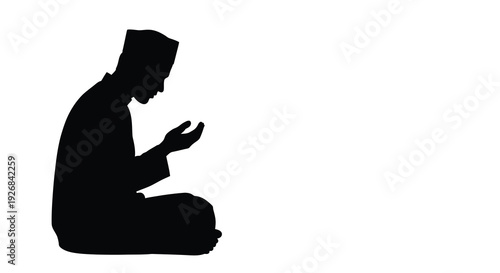 A man in prayer kneeling with hands raised black silhouette