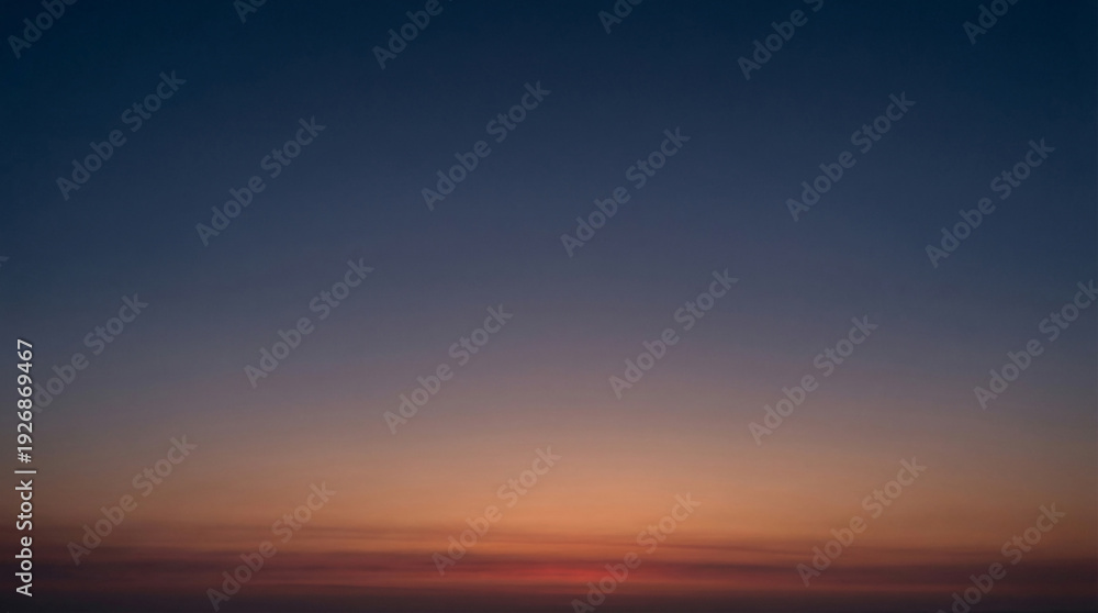 Fototapeta premium Smooth gradient sky transitioning from deep blue to warm orange and red hues capturing the serene atmosphere of dawn or dusk