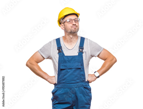Full length body of angry middle-aged construction worker with hands on waist looking to camera, isolated on white background. Displeased male builder stare to you. Craftsman against white wall