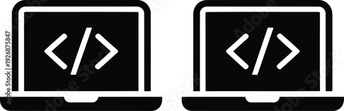 Two laptops displaying code symbols on their screens side by side.