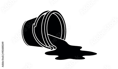 A black paint bucket lying on its side with spilled paint