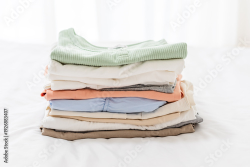 Canvastavla Clothes stacked on a bedroom bed