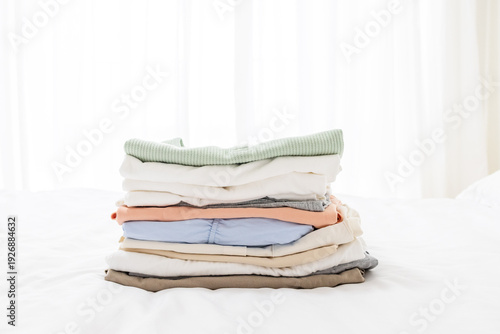 Konstfotografi Clothes stacked on a bedroom bed