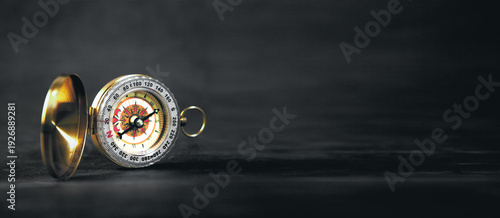 Принти на полотні a closeup of a compass on a black background