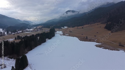 Aerial view of the frozen Wagenbruchsee, Geroldsee in Kruen, Bavaria. A snowy winter landscape in the Karwendel Alps. This lake is a highly popular tourism destination in Germany.
