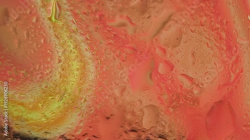 Abstract close-up of vibrant red and yellow fluid patterns with organic textures on a flat surface with warm tones.