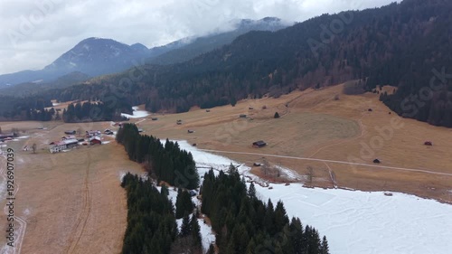 Winter landscape of Wagenbruchsee Geroldsee from above. Snowy lake in the Kruen region of Germany. A popular tourist hub in the heart of the Bavarian mountain range.