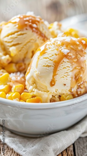Corn ice cream served with caramel sauce in a bowl on a rustic wooden table with a simple cloth napkin