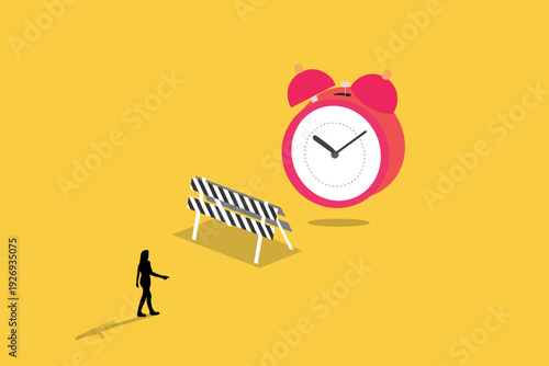 Business woman walking toward a giant alarm clock behind a road barrier, representing time management, project deadlines, and overcoming delays