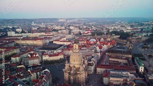 A circular aerial shoot of the Frauenkirche with Dresden's Old Town and the River Elbe behind in Dresden in Germany at dawn