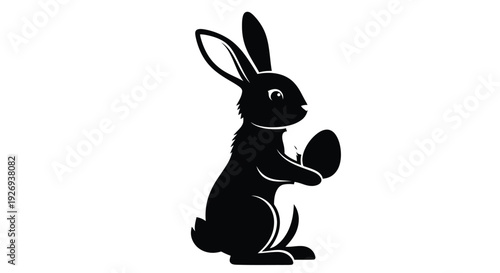 A black silhouette of a rabbit holding an Easter egg against a white background.