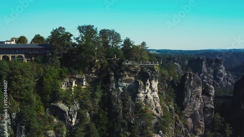 Aerial footage circling the mountaintop viewing platform in the Amselgrund valley, located in the Saxon Switzerland National Park, Germany