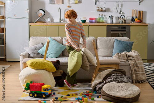 Billede på lærred Little boy cherishes joyful playtime in a cozy living room filled with colorful