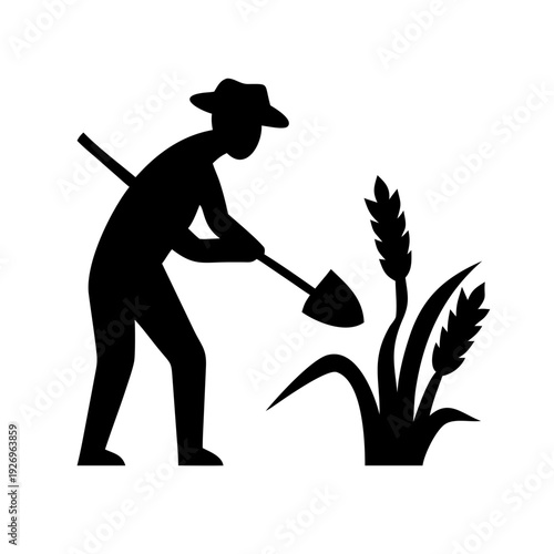 Man in silhouette planting wheat with shovel