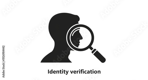 Identity verification concept with magnifying glass focusing on human face silhouette.