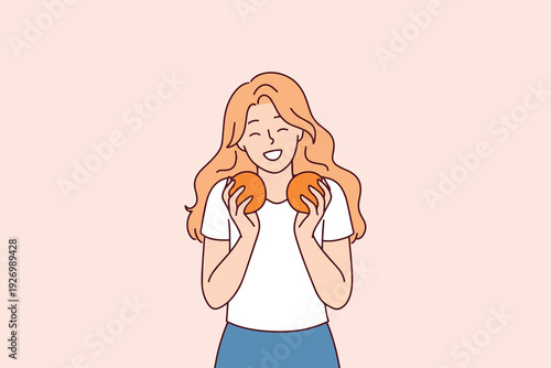 Happy smiling woman holds fresh oranges, symbolizing healthy lifestyle and organic nutrition. Concept of mindful eating, vegan diet, and natural vitamin source without gmo for wellness.