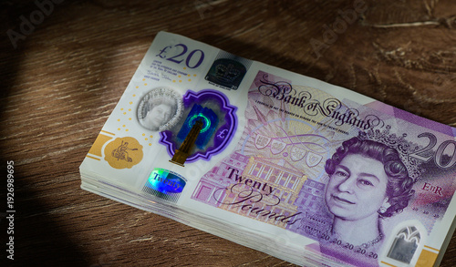Stack of 20 GBP Notes on Wooden Table